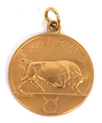 Lot 170 - A 9ct Taurus pendant, the front with relief...
