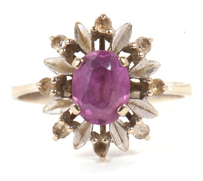 Lot 27 - A pink sapphire and white stone ring, the oval...