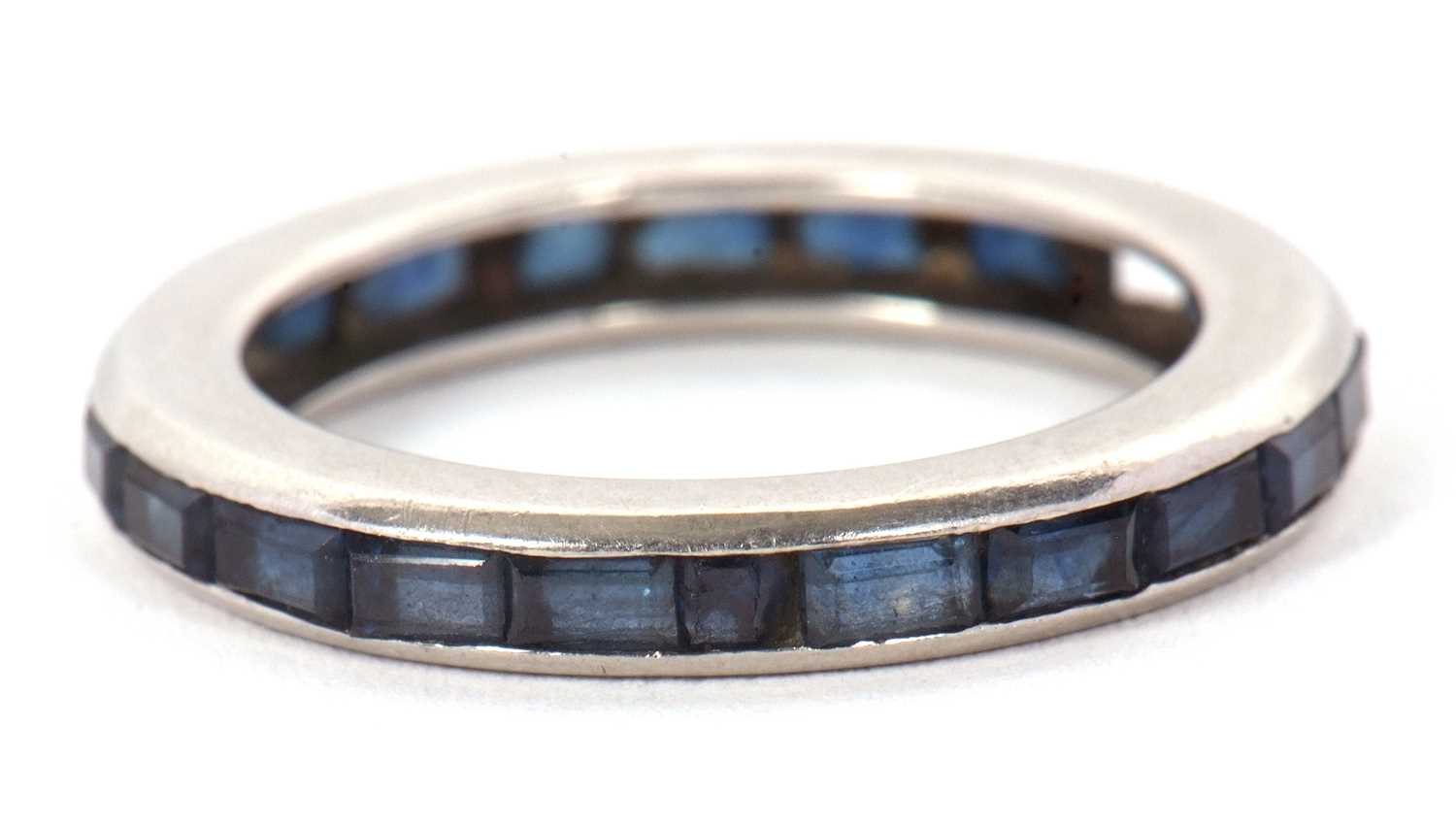 Lot 24 - A sapphire eternity ring, channel set with...