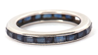 Lot 24 - A sapphire eternity ring, channel set with...