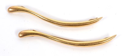 Lot 151 - Two gold hair clips, the elongated S-shape...