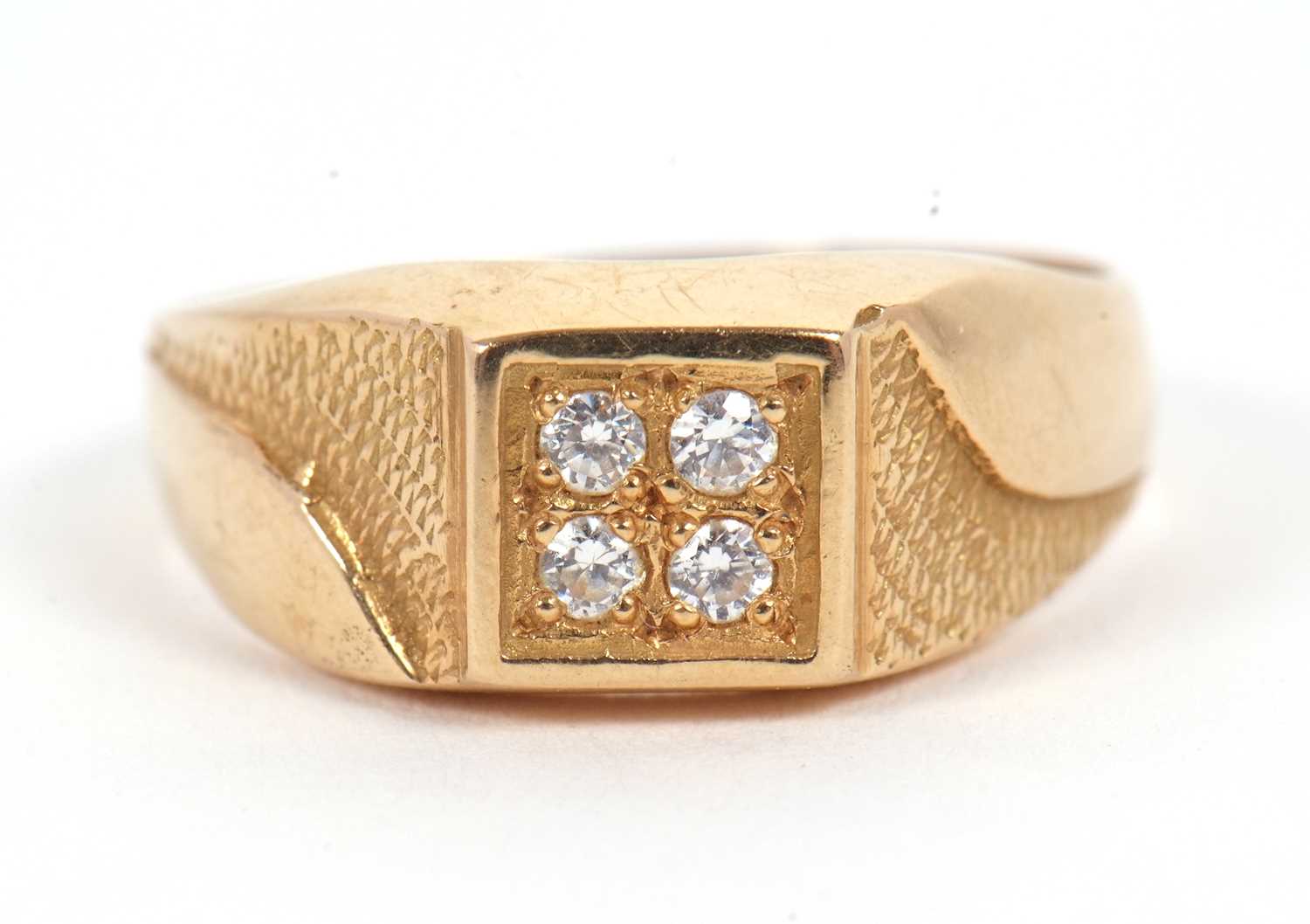 Lot 6 - A gentleman's dress ring, the central squared...