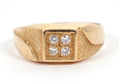 Lot 6 - A gentleman's dress ring, the central squared...