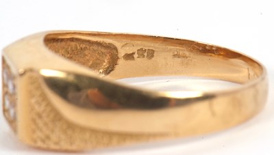 Lot 6 - A gentleman's dress ring, the central squared...