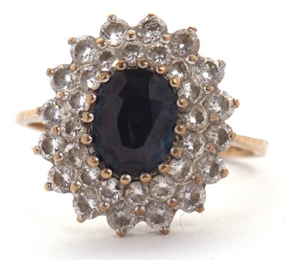 Lot 10 - A 9ct sapphire cluster ring, the central oval...