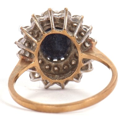 Lot 10 - A 9ct sapphire cluster ring, the central oval...