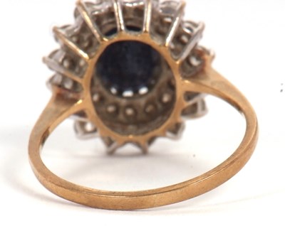 Lot 10 - A 9ct sapphire cluster ring, the central oval...