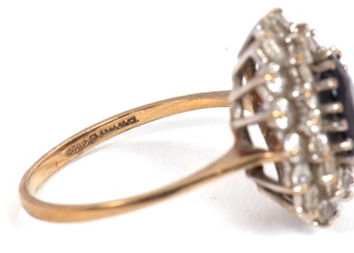 Lot 10 - A 9ct sapphire cluster ring, the central oval...