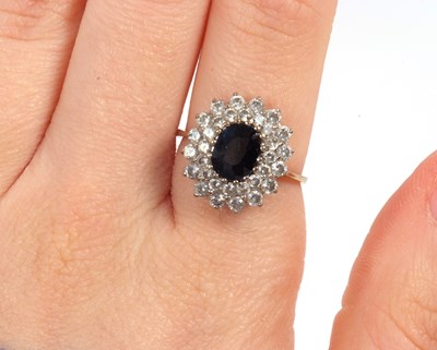 Lot 10 - A 9ct sapphire cluster ring, the central oval...