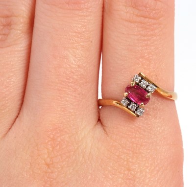 Lot 38 - A ruby and diamond ring, the oval ruby set...