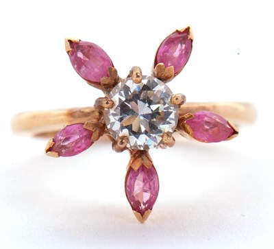 Lot 25 - A pink sapphire and CZ ring, the central round...