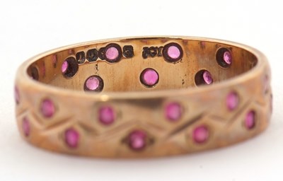 Lot 34 - A 9ct ruby ring, the 4mm wide band set with...