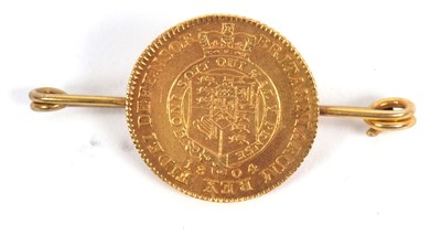 Lot 178 - A half guinea coin brooch, the 1804 half...
