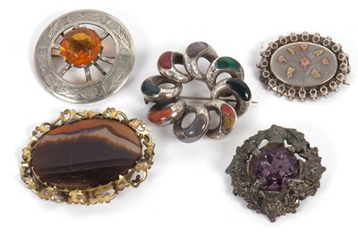 Lot 193 - Five brooches: to include a looped agate set...