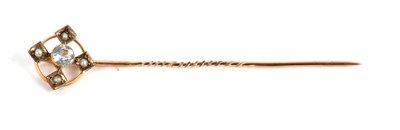 Lot 104 - An aquamarine and seed pearl stick pin, set...