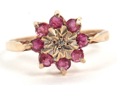Lot 30 - A 9ct ruby and diamond cluster ring, set to...