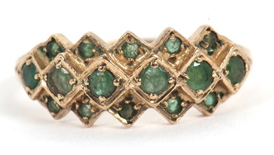 Lot 36 - A 9ct emerald ring, set with a central row of...