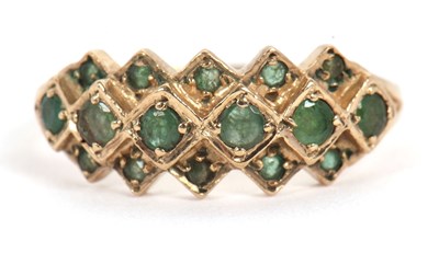 Lot 36 - A 9ct emerald ring, set with a central row of...