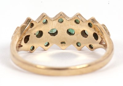 Lot 36 - A 9ct emerald ring, set with a central row of...