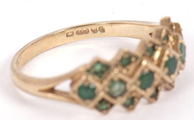 Lot 36 - A 9ct emerald ring, set with a central row of...