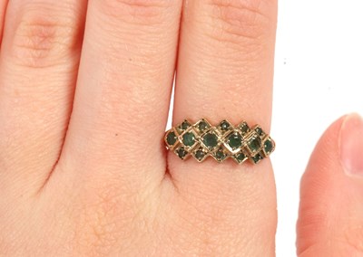 Lot 36 - A 9ct emerald ring, set with a central row of...