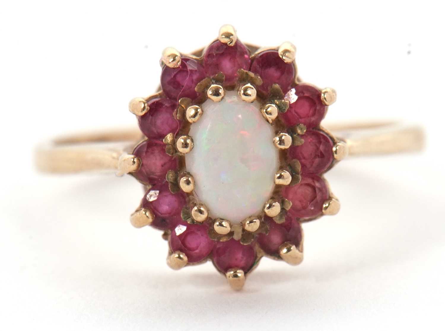 Lot 46 - A 9ct opal and ruby ring, the central oval...