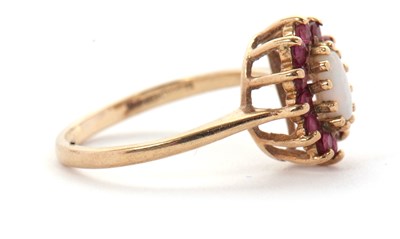 Lot 46 - A 9ct opal and ruby ring, the central oval...