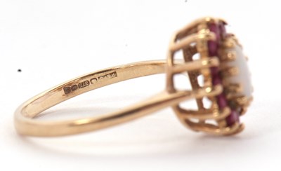 Lot 46 - A 9ct opal and ruby ring, the central oval...