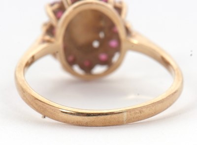 Lot 46 - A 9ct opal and ruby ring, the central oval...