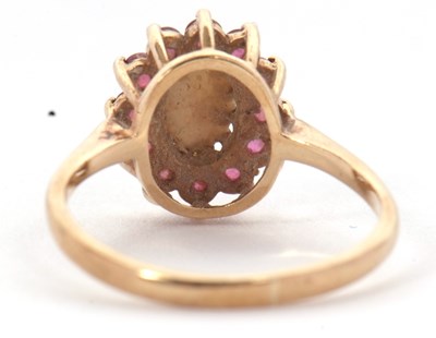 Lot 46 - A 9ct opal and ruby ring, the central oval...