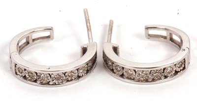 Lot 94 - A pair of diamond earrings, the adapted...