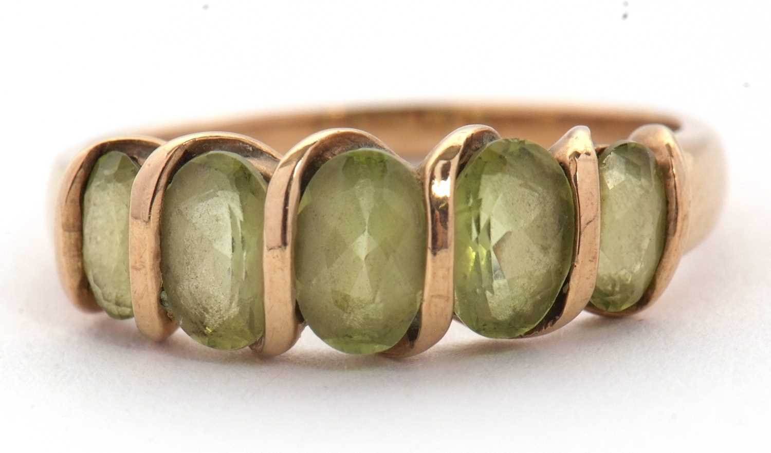 Lot 52 - A five stone peridot ring, set with five...