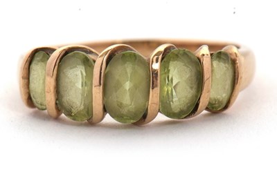 Lot 52 - A five stone peridot ring, set with five...