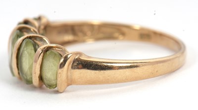 Lot 52 - A five stone peridot ring, set with five...