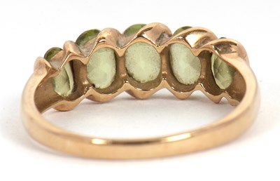 Lot 52 - A five stone peridot ring, set with five...
