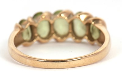 Lot 52 - A five stone peridot ring, set with five...