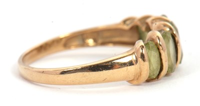 Lot 52 - A five stone peridot ring, set with five...