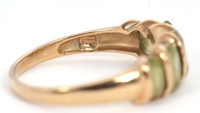 Lot 52 - A five stone peridot ring, set with five...