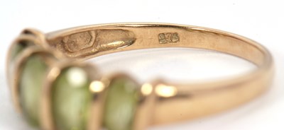 Lot 52 - A five stone peridot ring, set with five...