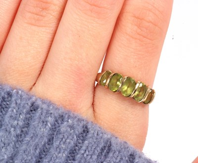 Lot 52 - A five stone peridot ring, set with five...