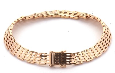 Lot 184 - A gate bracelet, 7mm wide, with integrated...