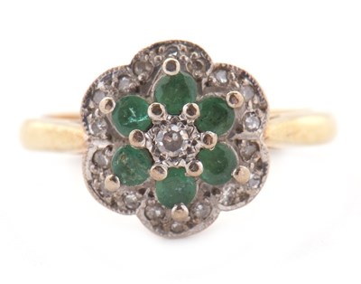 Lot 70 - An 18ct emerald and diamond cluster ring,...