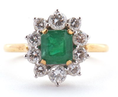 Lot 74 - An 18ct emerald and diamond ring, the central...