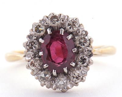 Lot 65 - A ruby and diamond ring, the oval ruby...