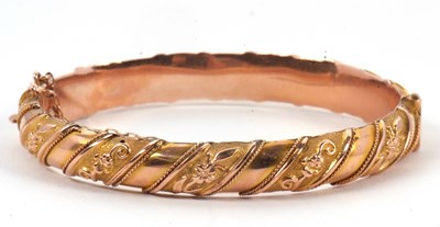 Lot 147 - A 9ct bangle, the hinged bangle with lightly...