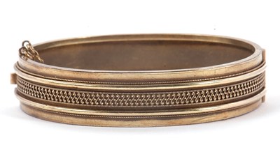 Lot 150 - An Archeological Revival bangle, the hinged...