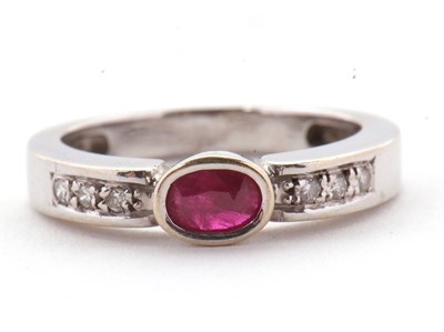 Lot 28 - An 18ct ruby and diamond ring, the central...