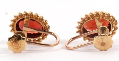 Lot 95 - A pair of garnet earrings, the oval collet...