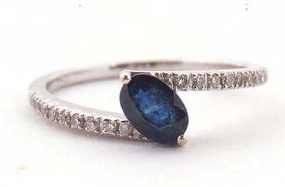 Lot 16 - A sapphire and diamond crossover ring, the...