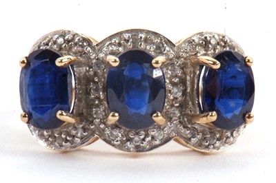Lot 60 - A 9ct sapphire and diamond ring, the three...